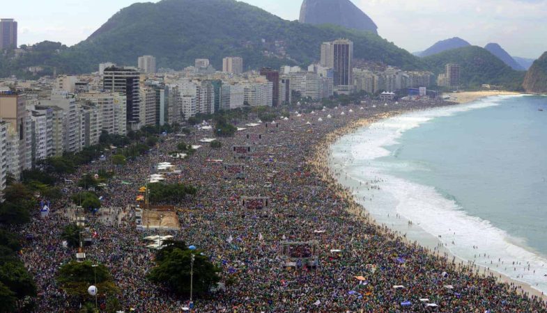 Hundreds of thousands of people crowd Copacabana beach in Rio de Janeiro on July 28, 2013 as Pope Francis celebrates the final mass of his visit to Brazil. Throngs of pilgrims attending World Youth Day (WYD) spent the night sleeping on the beach before Sunday's final mass, while the city's mayor said he expects up to three million people to pack the beach for the occasion.   AFP PHOTO / TASSO MARCELO        (Photo credit should read TASSO MARCELO/AFP/Getty Images)
